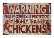 "Retro tin sign featuring a chicken with the caption 'HIGHLY TRAINED' in a vintage style."