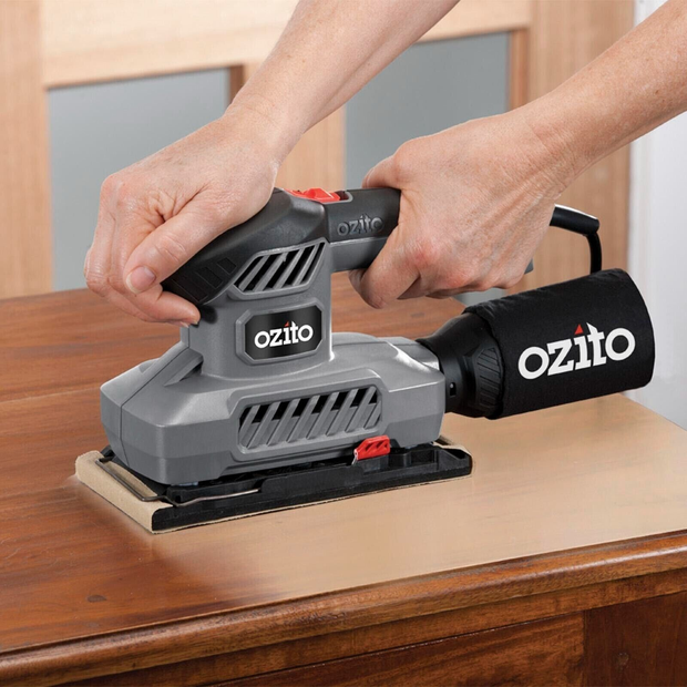 Ozito power sander with sandpaper sheets 
